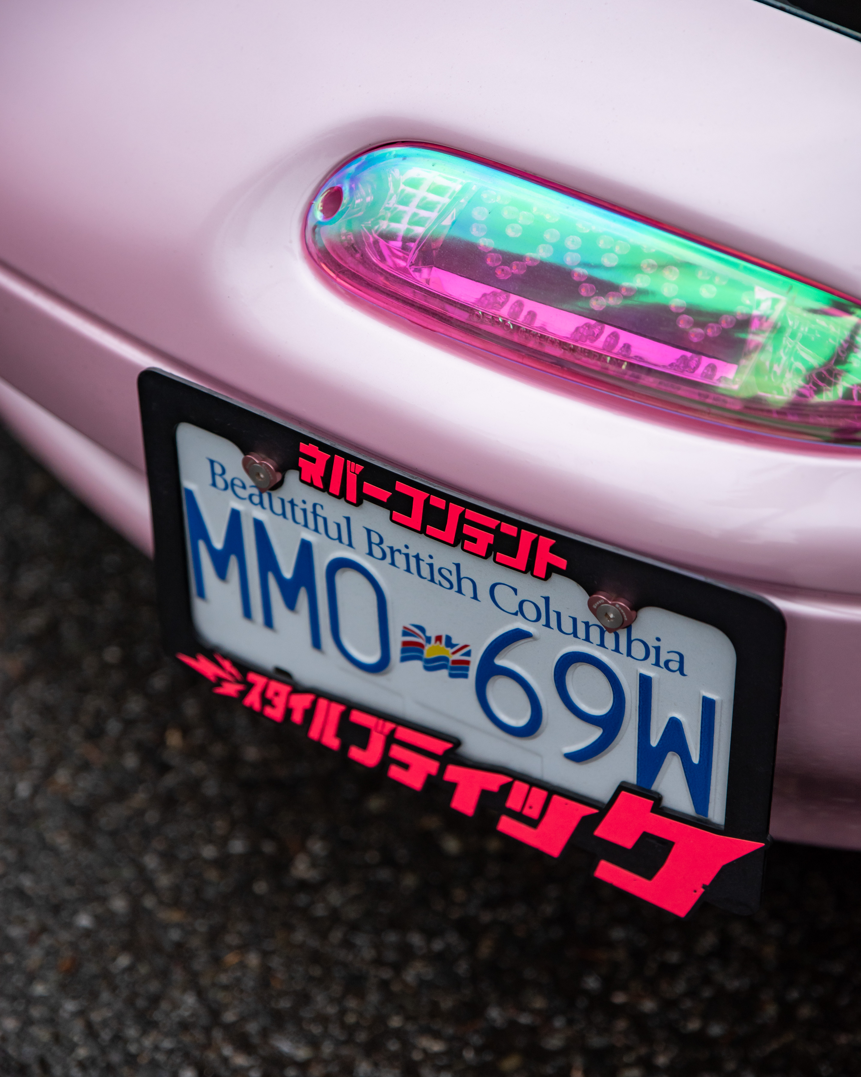 Pink heart shaped license plate frame M6 screws on a miata car