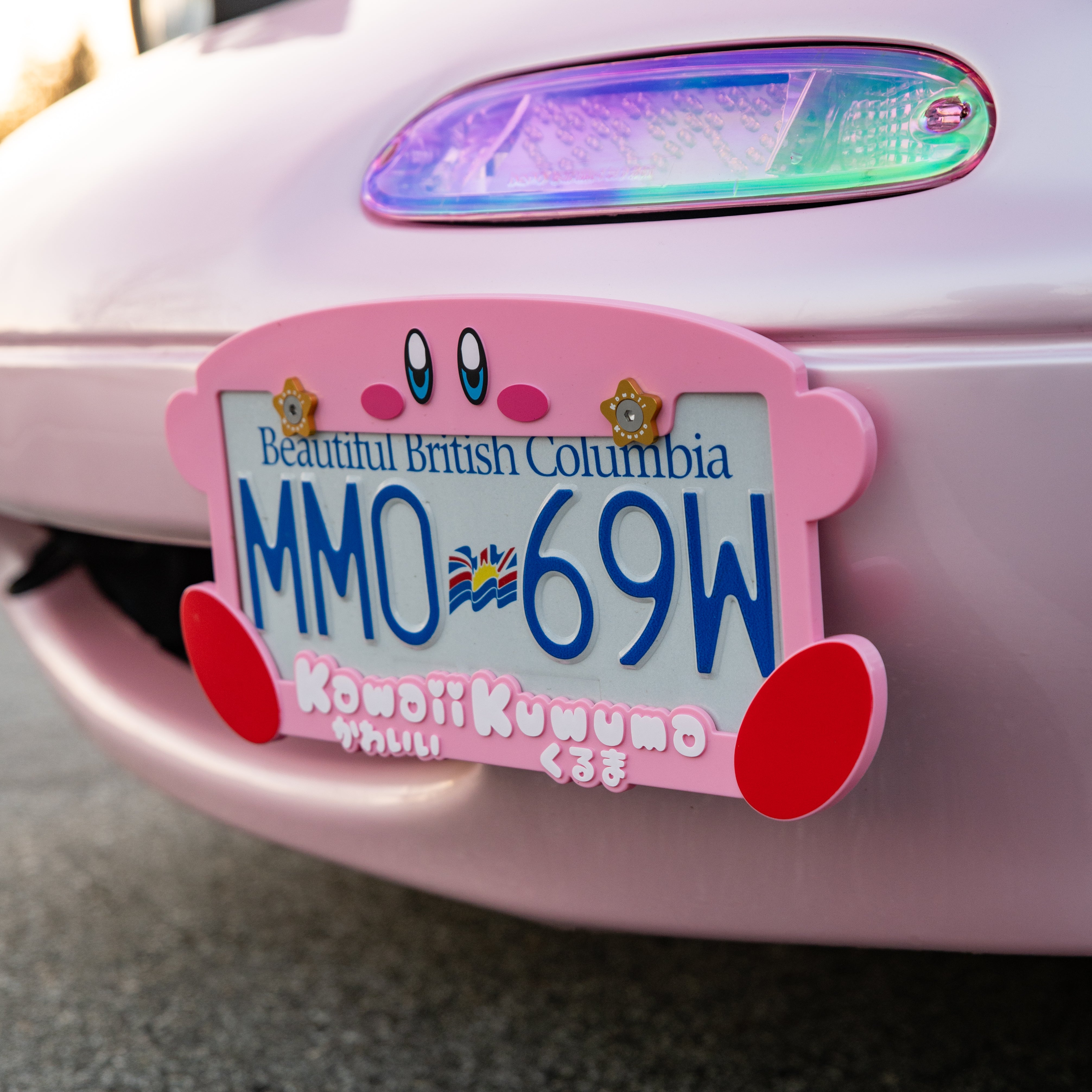 cute kirby license plate on a pink miata as seen on tiktok with gold or yellow star dress up hardware