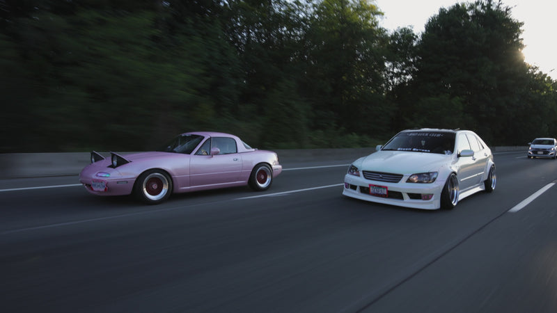 roller video of pink miata and white is300